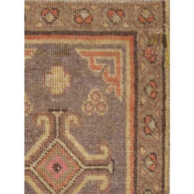 This Early 20th century East Turkestan Khotan rug, measuring 1' 4" x 2' 2", exemplifies the distinctive artistic...
