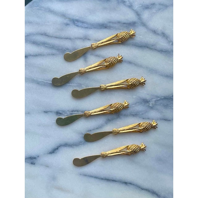 Welcome guests with this dazzling vintage set of 24K Gold-plated Pineapple Spreaders. Pineapples, a symbol of hospitality...