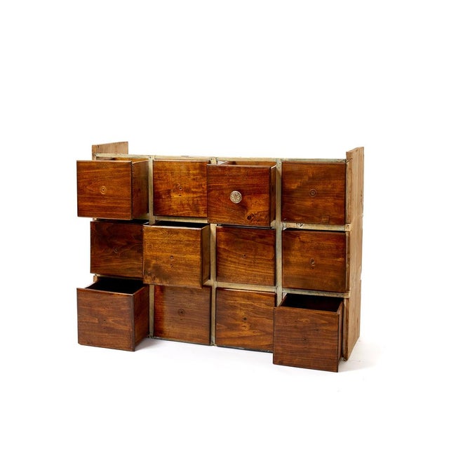 Poplar chest of drawers, used to store small objects or grains. It has twelves numbered lacquered drawers with...