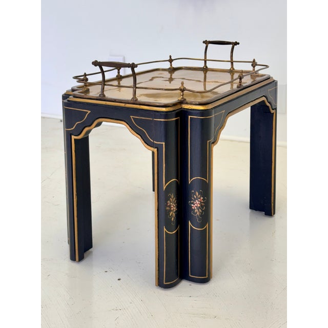 A Regency style side table in black lacquer with gilt detailing, hand-painted Chinoiserie floral decoration, and an...