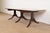 An exceptional Georgian or Regency Revival style carved mahogany drop-leaf extension dining table In the manner of Drexel...
