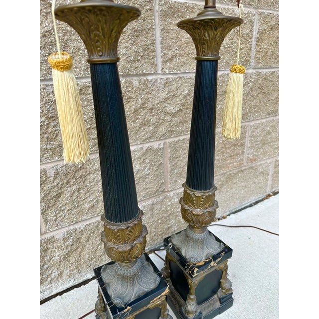 This pair of vintage neoclassical table lamps features a unique design with a combination of dolphin and serpent elements....