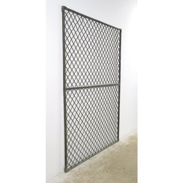 Industrial style steel security panel made of woven wire in a diamond pattern with a rectangular frame. The panel is ideal...