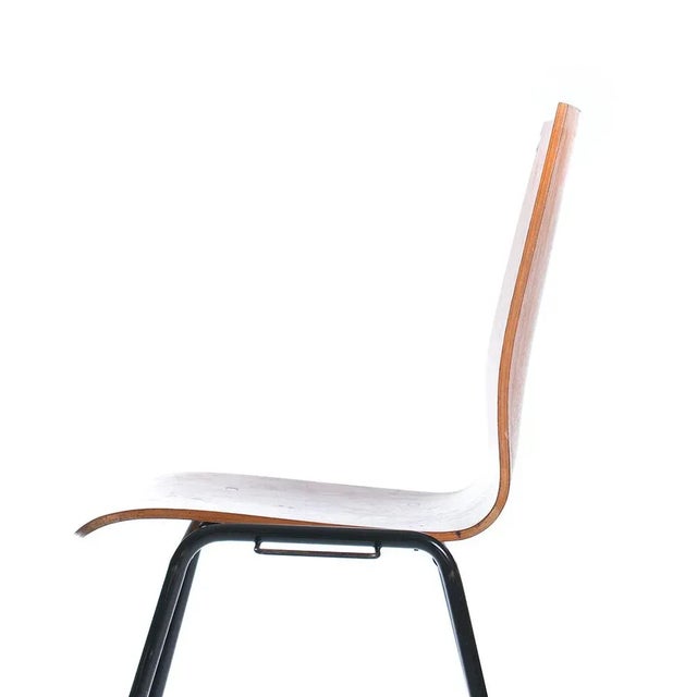 This really nice stacking chair was produced in Germany in the 1960s. The seat is made of bent teak plywood and it sits on...