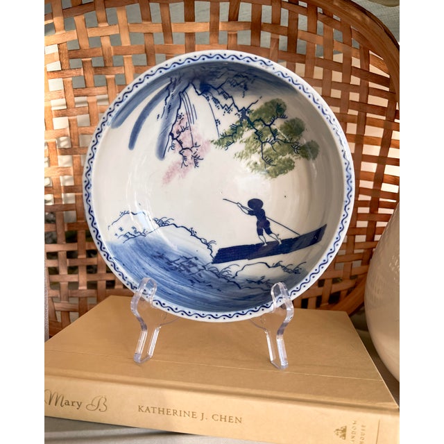 A beautifully expressive antique blue and white porcelain bowl, hand-painted with a charming riverside fisherman scene...