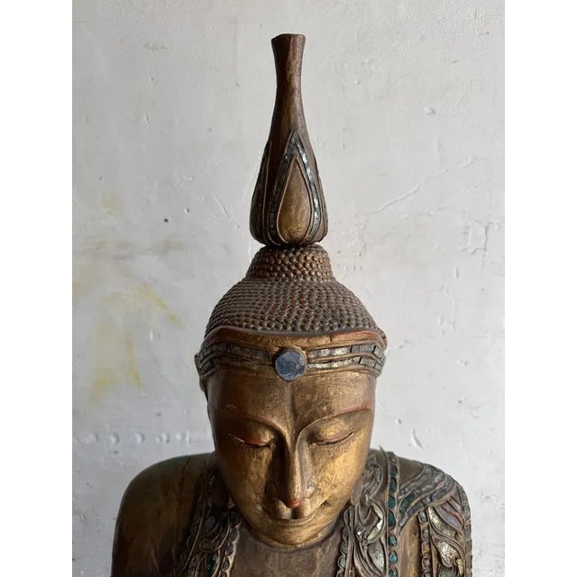Large seated buddha sculpture on carved base – gilded wood & lacquer a serene and majestic seated buddha sculpture ,...
