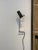 A striking pair of Mid-Century Modern inspired wall sconces, combining slim polished chrome stems with sculptural black...