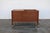 A distinctive Mid-Century Modern walnut coffee table, circa 1960s, combining beautiful craftsmanship with clever...
