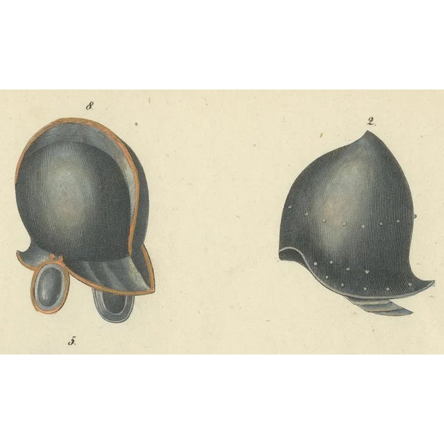 Title: 19th-Century Hand-Coloured Lithograph of Medieval and Renaissance Helmets : This hand-coloured lithograph features...