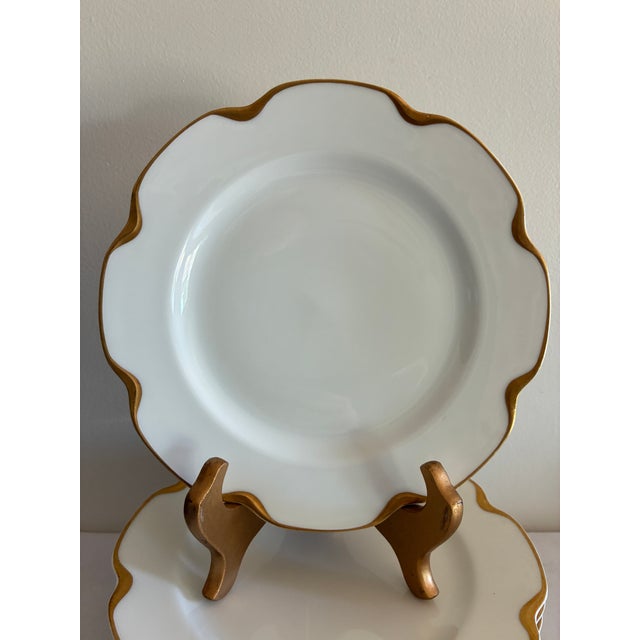 An elegant set of 10 vintage Haviland & Co. Limoges porcelain plates, each with a graceful wavy scalloped edge finished in...