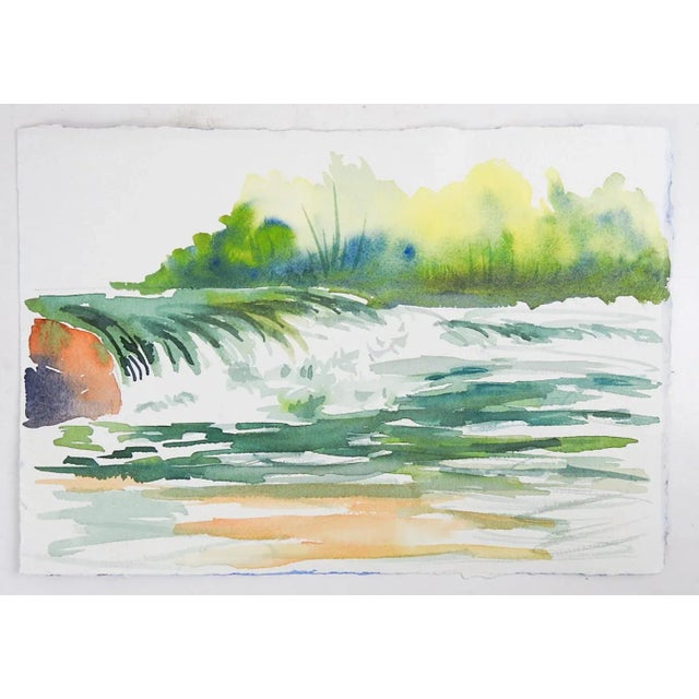 Small late 20th century watercolor on paper painting of an old barn with blue and red wildflowers in landscape. Has...