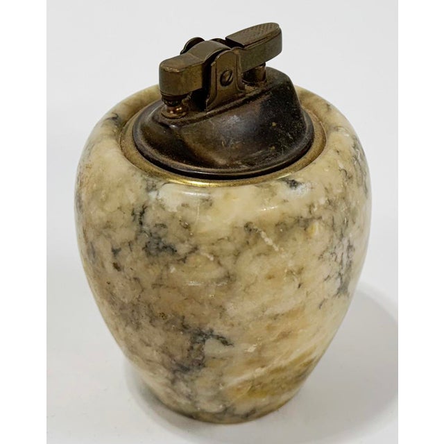 Vintage round stone table lighter with brass fitting. Measures 3"H to top of stone base. Age wear. No chips or cracks....