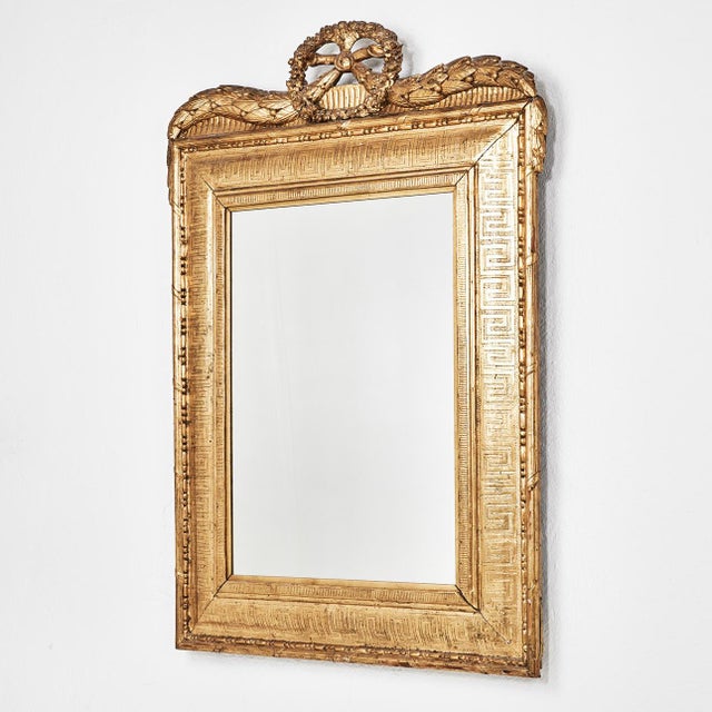A striking Northern European neoclassical mirror dating to the second half of the 18th century. Crafted in carved wood...