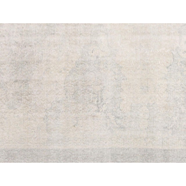 Handwoven wool-on-wool Oushak rug from vintage Turkey, measuring 6'11" x 10'1". Originating from the storied weaving...