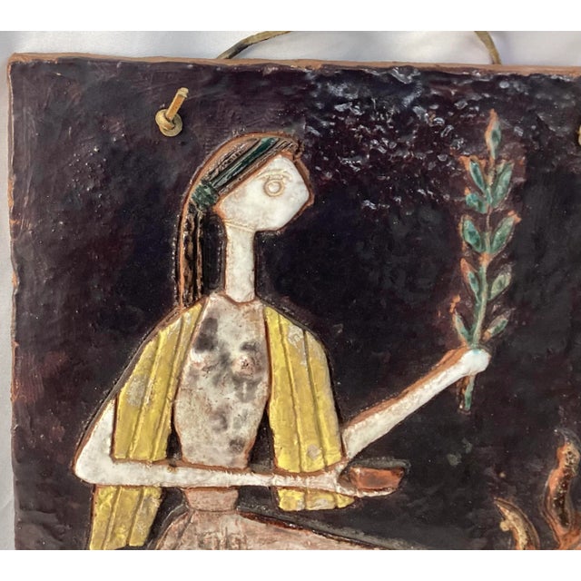Unique ceramic art plaque of The Oracle of Delphi. The plaque has a leather hanger at top to hang on wall. Contains colors...