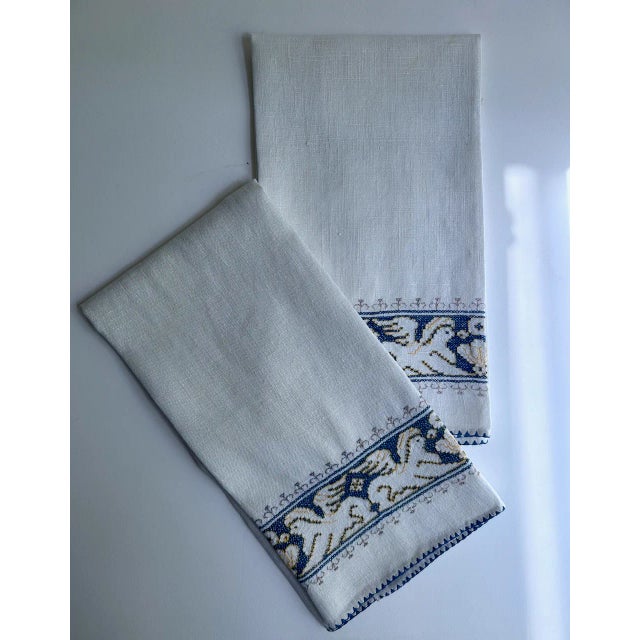 Pair of vintage handcrafted White Linen Guest Towels with Blue embroidered Gryphons. Featuring woven rectangular White...