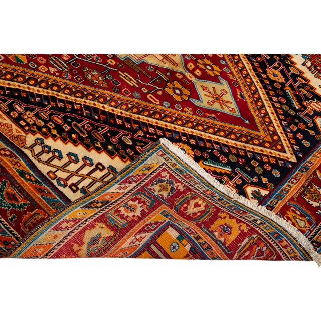 Beautiful Vintage Shiraz hand-knotted Wool rug with the red field. This Shiraz rug has a multicolor accents in all over...