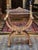 Armchair made of solid walnut decorated with hand-carved Mascaras, acanthus leaves and a large scale pattern. Scissor...