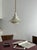 When lit, a warm cream glow fills the gaps between the stacked tiers and spreads out under the wide brim. This is what...
