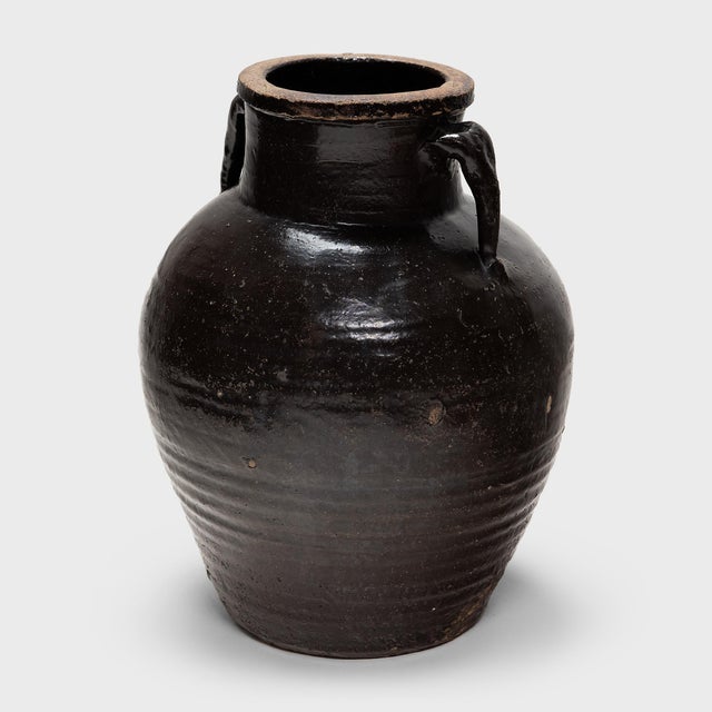 Originally used for fermenting rice or sorghum into vinegar, this earthenware vessel from the early 20th century is coated...
