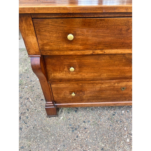 A fine French Louis Philippe walnut commode featuring three spacious drawers with beautifully figured walnut veneers,...