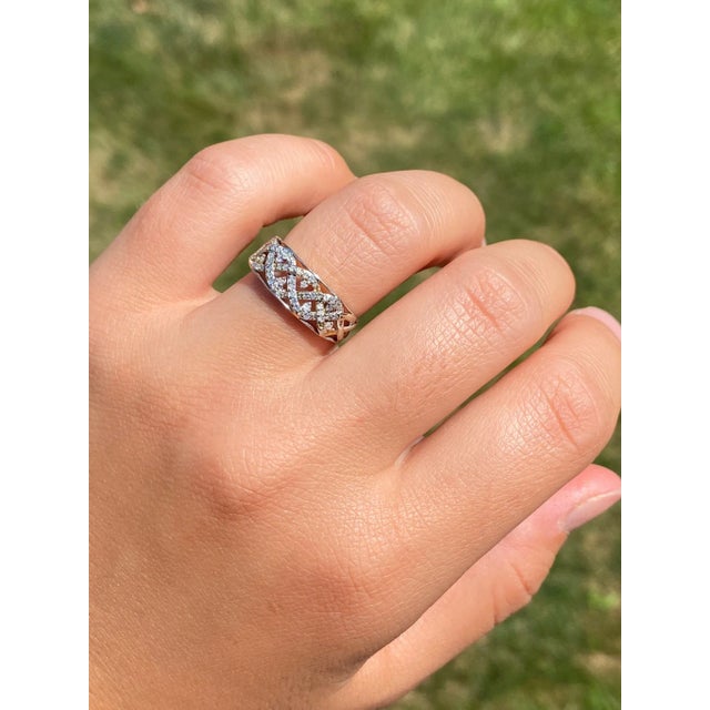 The Eastpoint: Antique White Gold Weaved Diamond Ring. The ring features old cut round diamonds shared prong set in weaved...