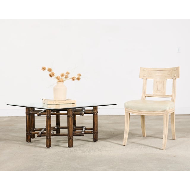 An handsome and authentic late 20th century rattan, brass, and glass coffee or cocktail table made in the California...