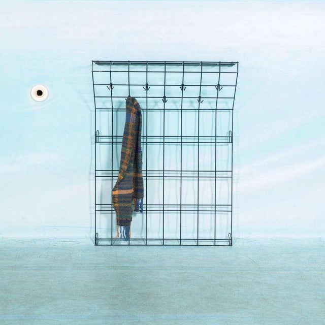 Minimalist designed coat rack from the sixties made entirely of black wire steel. A rack with vertical and horizontal rods...