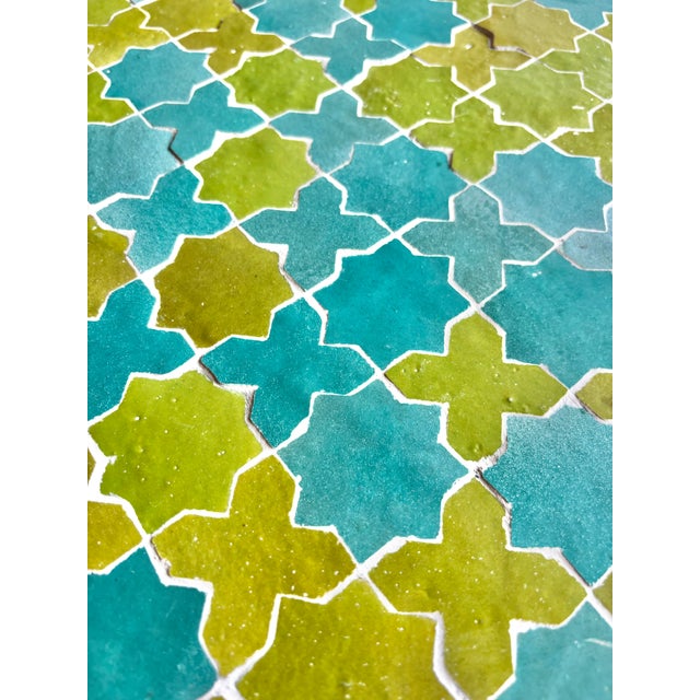 Contemporary round coffee table handcrafted in Morocco using traditional zellige techniques. Its colorful tabletop...