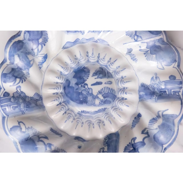 Rare 17th century faience Frankfurt Delftware glazed melon form charger with chinoiserie figures. A truly marvelous...