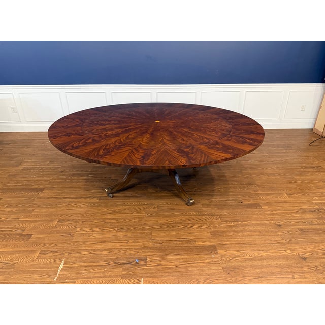 This is a magnificent large round mahogany perimeter leaf table by Maitland-Smith. It is the Roundabout Dining Table. The...
