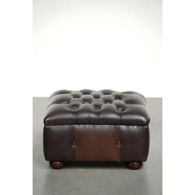 This beautiful cowhide Chesterfield ottoman is crafted in the English style and features stunning colors. A footstool,...