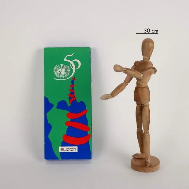 Clock commemorating the fiftieth anniversary of the UN. Cardboard packaging. This piece is attributed to the mentioned...