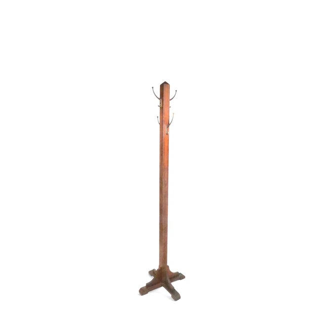 Arts and Crafts, Mission style coat / hat rack, having two sets of four brass hooks, each with an upper hook. This example...