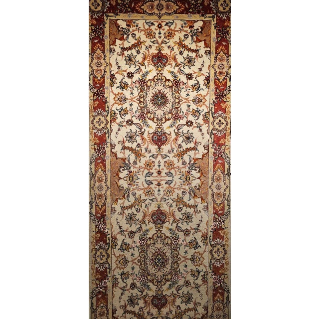"This elegant vintage Persian Tabriz runner features a refined floral design hand-knotted with a wool pile on a cotton...