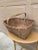 A beautifully woven early 20th century American splint oak basket with warm honeyed tones and a tightly constructed...