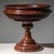 Classical dark red marble tazza with white veining, featuring a round baluster foot and a multi-profiled bowl. The piece...