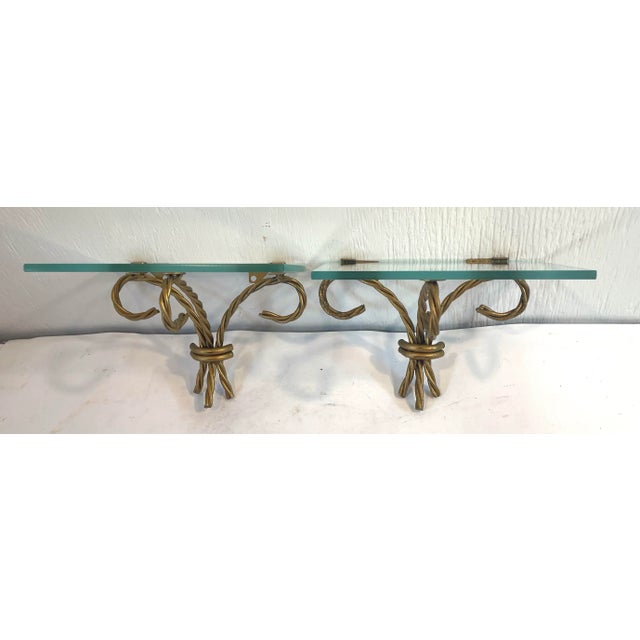 Pretty Hollywood Regency pair of twisted metal and glass wall shelves