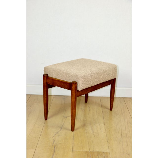 Edmund Homa stool with a beige and gold boucle seat. 2 pieces available. This Edmund Homa stool was designed and...
