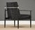 A mid century modern black cerused lacquer ebonized lounge chair with black vinyl upholstery and a stainless steel back...