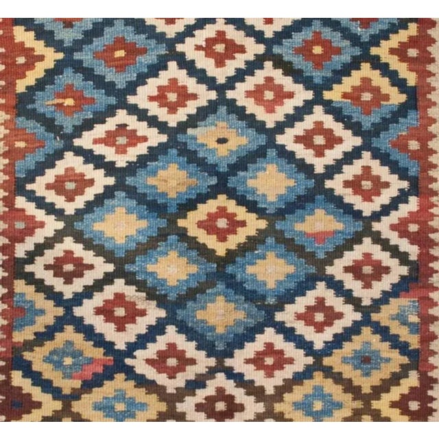 A beautiful early 20th Century Persian Saveh Kilim rug with alternating multicolored diamond patterns, with a pattern of...