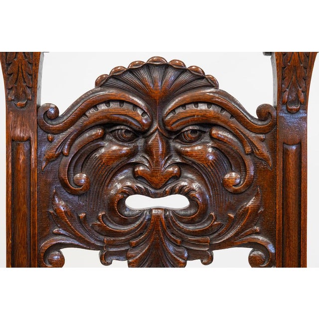 An intriguing Edwardian English oak chair with expressive Green Man carving. Circa 1900. A petite chair with refined...