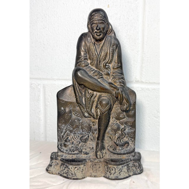 Up for sale is a thick antique gold gilded bronze Lord Sai Baba Idol doorstop statue. This handmade statue is a beautiful...