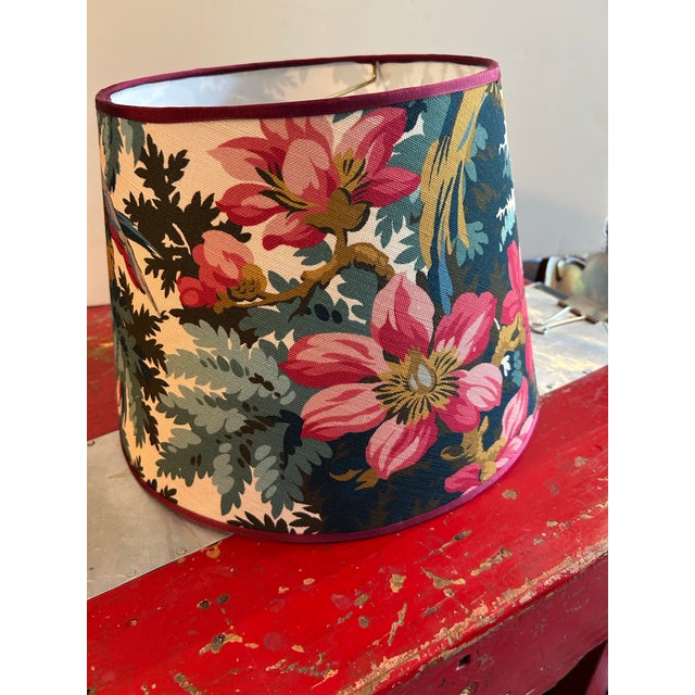 A washer top lampshade handmade with a charming floral and fauna motif. Measurements: top 10” bottom 14” side 10”