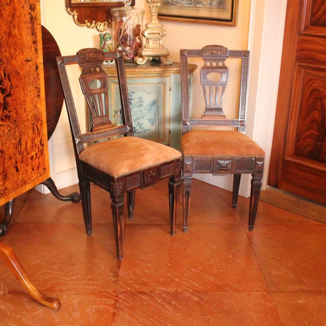 A chic pair of Swedish side chairs in dark walnut with natural suede leather upholstery and brass tacks. A very striking...