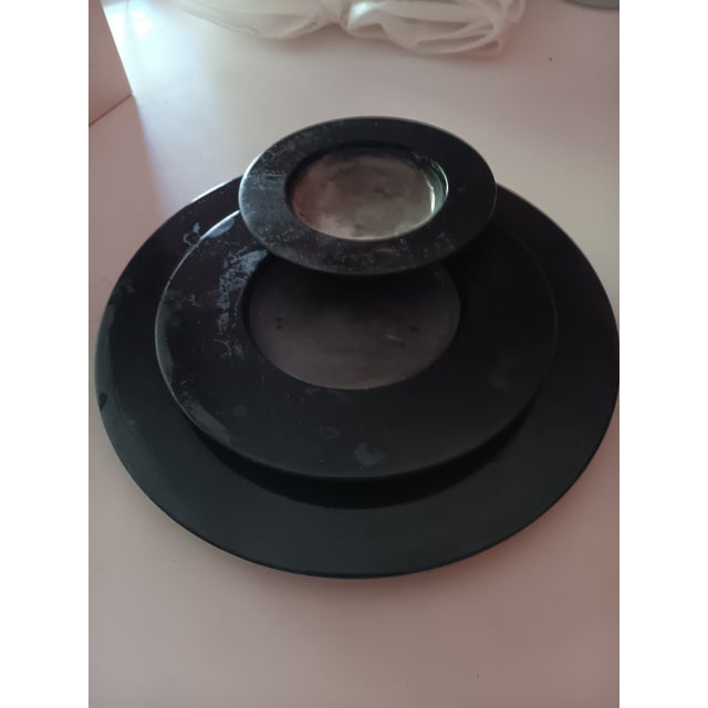 A set of three slate marble plates and works of ar t by Guilio lazzotti and manufactured by Achille Castiglioni. Each...