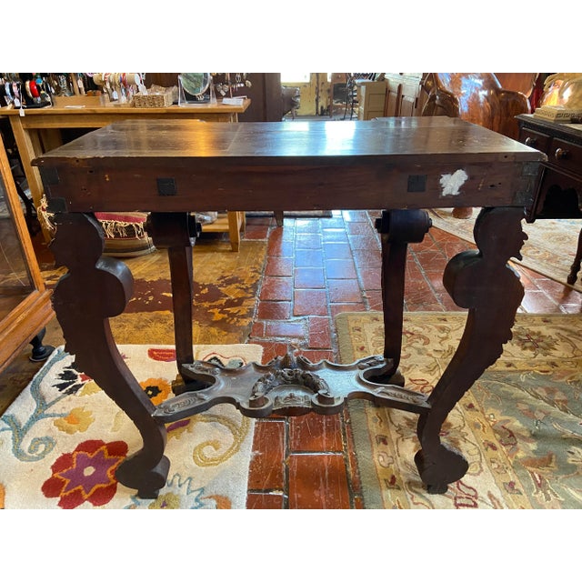 Intricately carved accent table with hidden drawer. This table is a very unique piece with carved cabriole legs with...