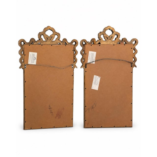 Matching pair of vintage gold wall mirrors by Carolina Mirror Company. Each features a rectangular beveled mirror plate...