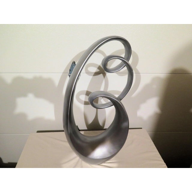 Large Late 20th Century sculptural polychrome sculpture. It's very modern Art Deco in concept. The fluid sweeps and swirls...