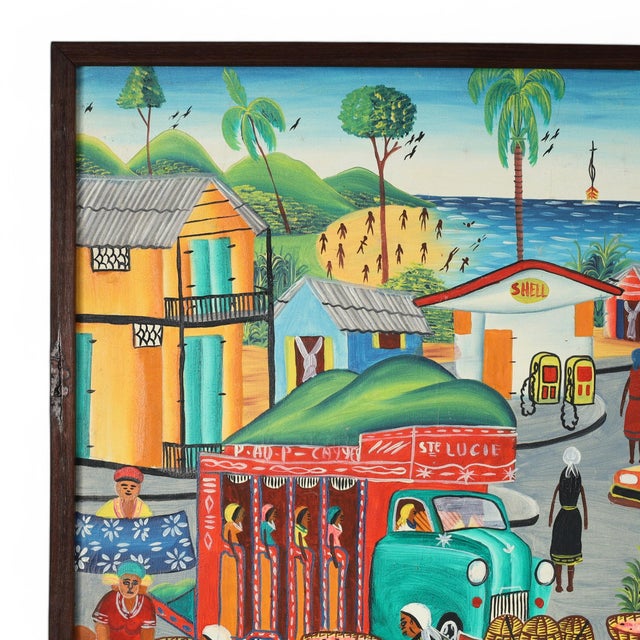 Striking Haitian acrylic painting on board depicting a busy street scene executed in a distinctive naive style with bold...